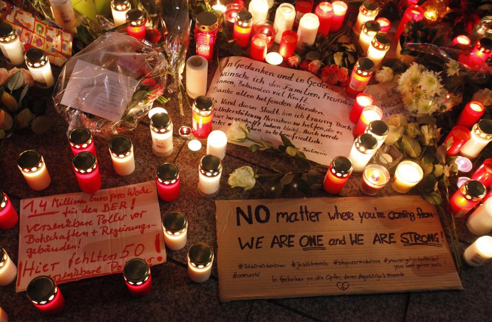  Candles and flowers sit among heartfelt messages left at the scene of yesterday's attack