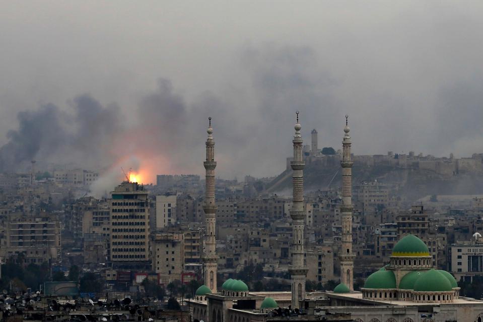 A ball of fire rises following an air strike hits insurgent positions in eastern neighborhoods of Aleppo, Syria, on December 5