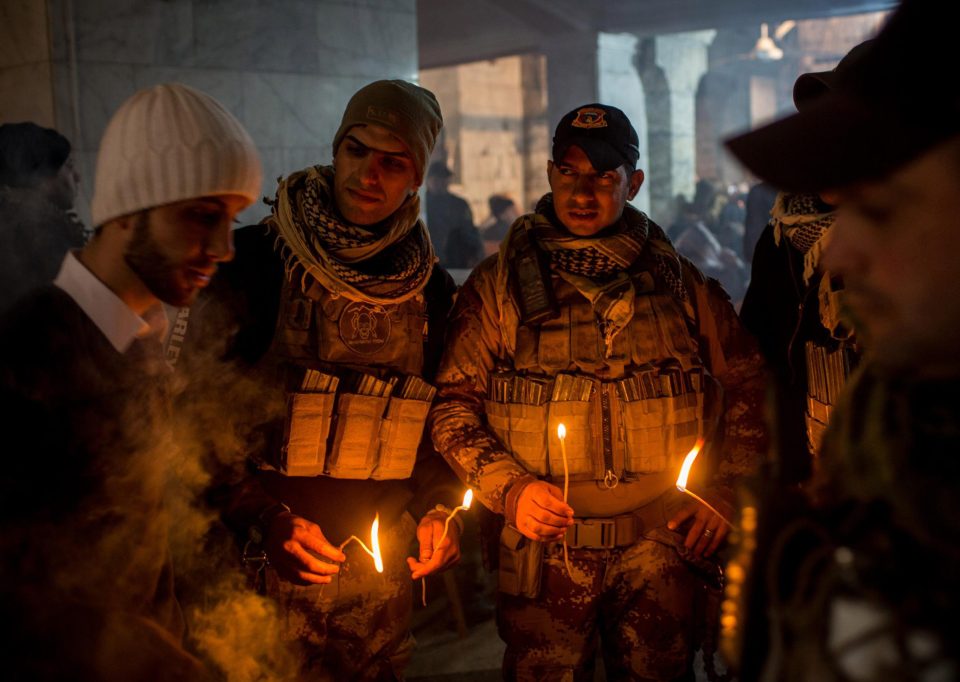  The Iraqi Special Forces troops light candles during a Christmas mass in Iraq