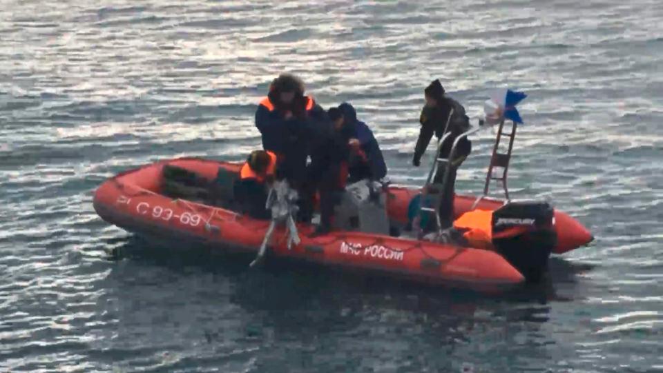 Rescue workers are seen pulling debris from the Black Sea 