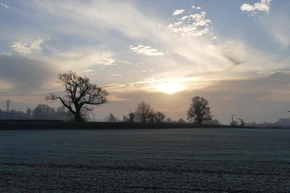 The days sun rises over the frost covered fields at Playhatch Oxfordshire - much of the country was blanketed with fog as the chilly day began