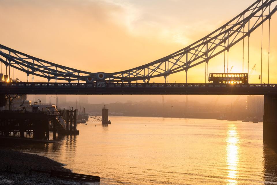  It was a foggy and hazy start to the day in London as the sun rises behind Tower Bridge in a scene which could fit into the countryside