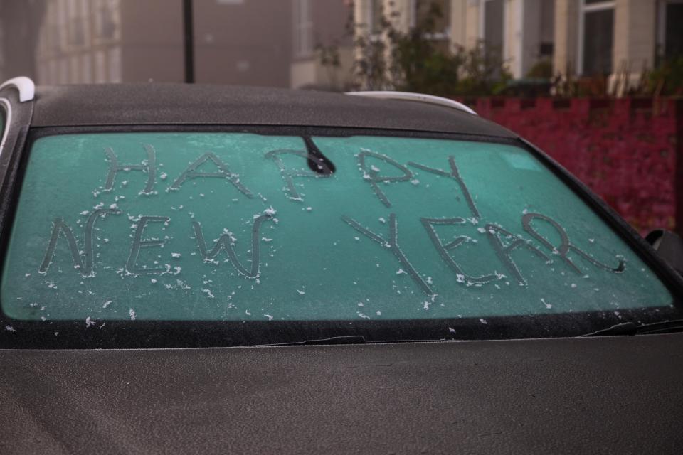  One person is getting ahead of themselves in wishing the driver of this frozen car a happy new year