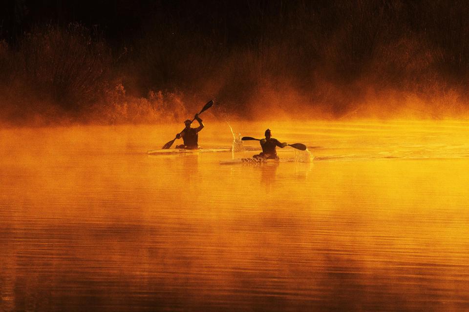  Kayakers make their way through the fog on the River Trent near Holme Pierrepont, Nottinghamshire, during a golden sunrise