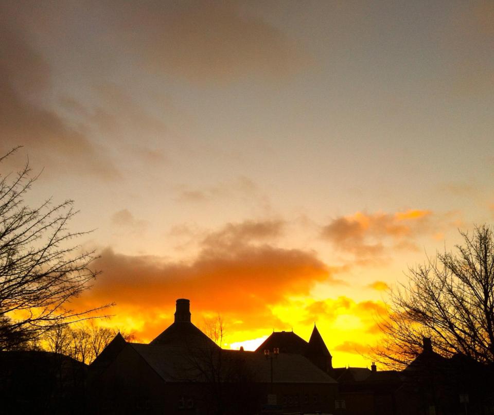  Sunrise over rooftops in Halifax West Yorkshire, sees in a chilly winters day