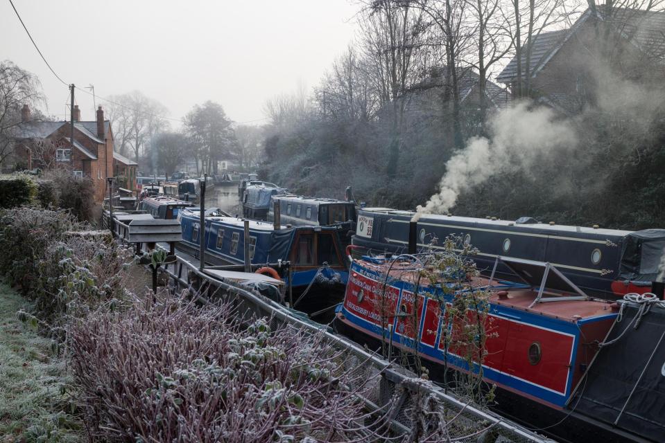 Narrowboats moored on the Saltisford Arm of the Grand Union Canal at Warwick on a freezing winter`s morning