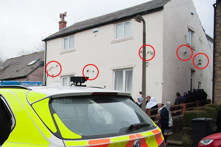  Armed cops were outside Mohammed Yassar Yaqub's home today as it was searched by police and a number of security cameras can be seen