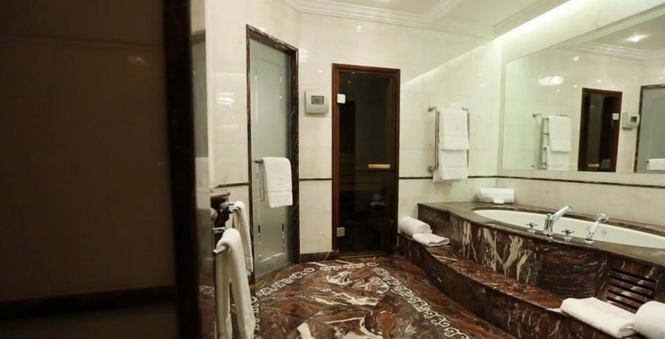  The marble bathroom has a separate shower and a large tub