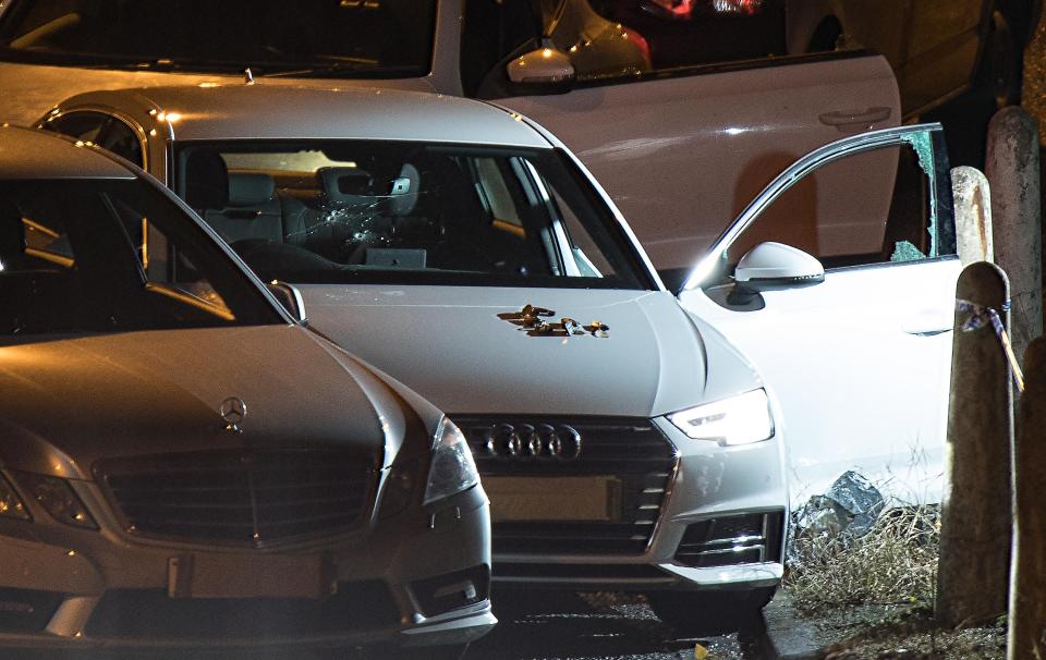 Shocking pictures from the scene show three bullet holes in the windscreen of a white Audi