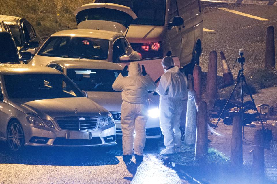 Forensic teams at work at the scene of last night's fatal shooting 