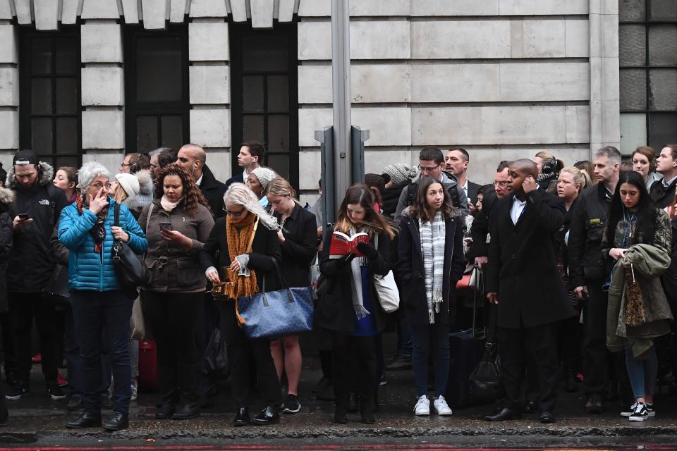 People wait patiently - or not so patiently - for a bus