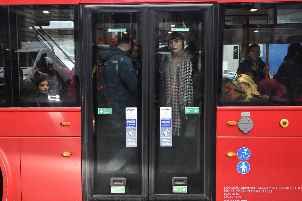 People stare desolately out of a bus window as they try to get to their destination