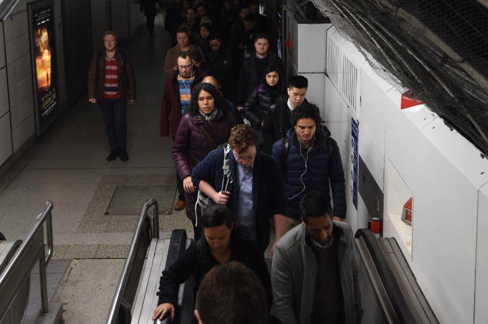 Passengers squeeze onto a DLR train in London after commuter's journeys were thrown into chais by a tube worker's strike