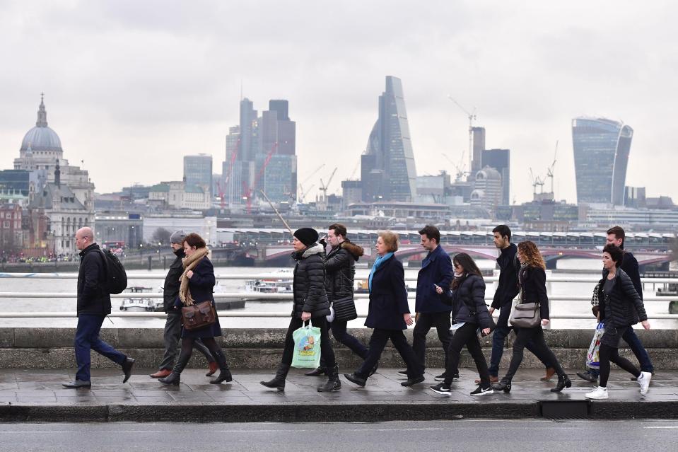 Commuters cross Waterloo Bridge in London
