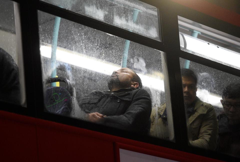 Amid the chaos, one Londoner attempts to have a snooze on the journey home
