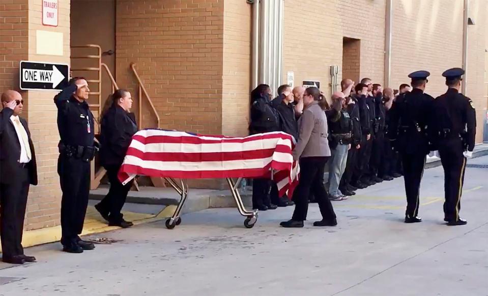  Officers salute the body of Master Sgt. Debra Clayton