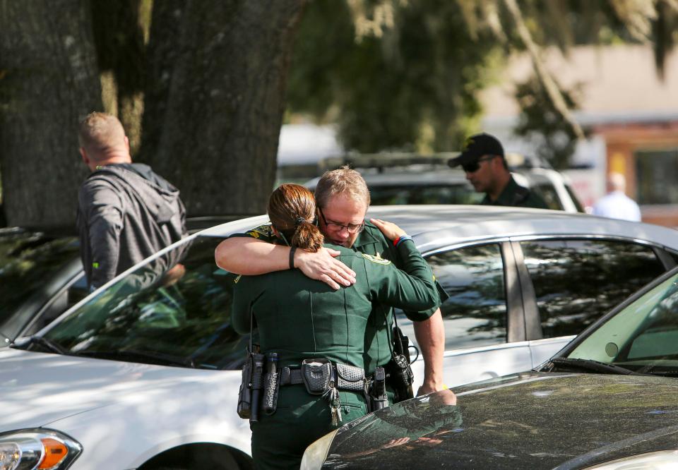  Officers comfort each other after news of the cop shooting broke