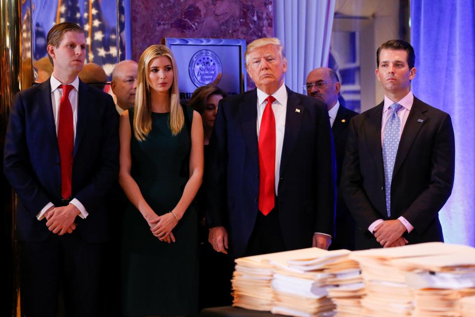  Trump stands surrounded by his son Eric (left) daughter Ivanka and son in law Jared Kushner (right) ahead of his press conference