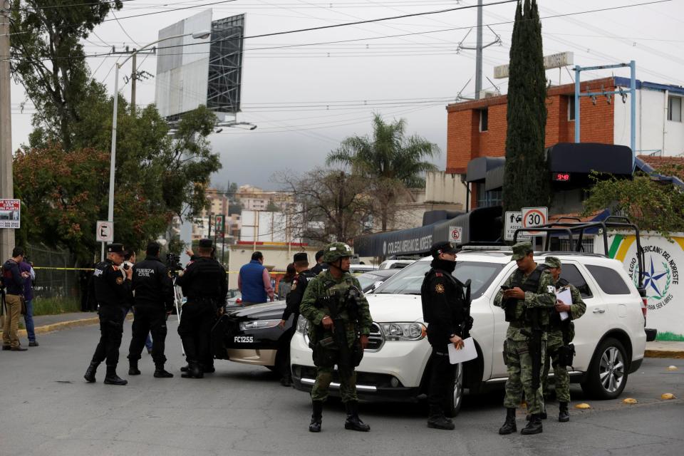  Cops gather at the scene of the school shooting in northern Mexico