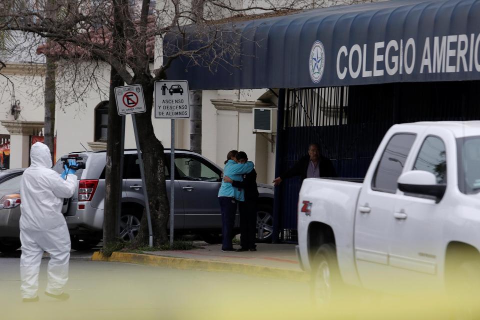  A couple hug outside the American college where the shooting occurred