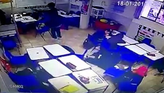  The shooter is seen pointing his gun at students cowering behind desks in the footage posted online