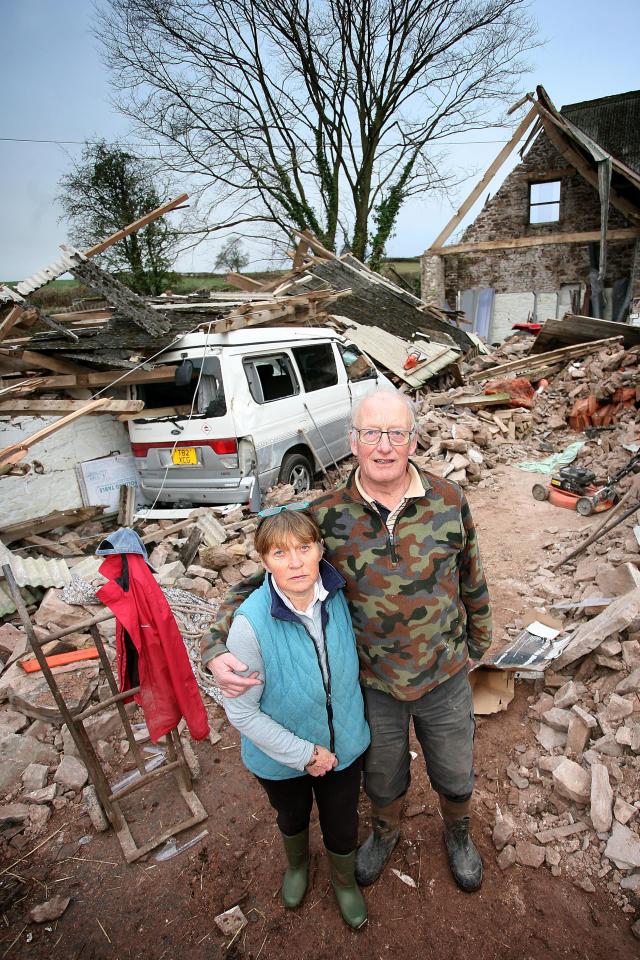  Mike Mellors and wife Peta, both pictured, stand amid the rubble of their destroyed barn