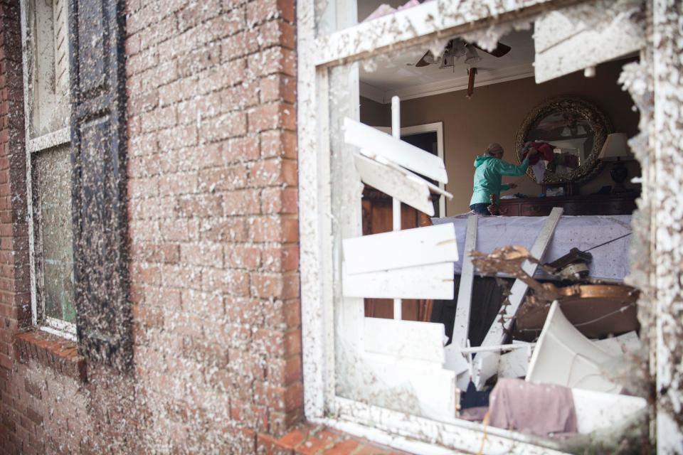  Marilyn Bullard looks through her parents bedroom after the home was damaged by a tornado in Adel, Georgia