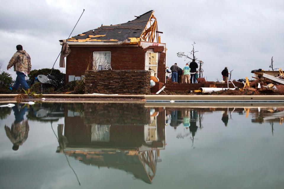 A storm damaged home in Adel, Georgia, where the roof has been torn off and debris lies on the ground