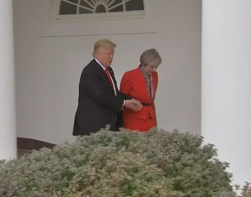  Trump and May were filmed holding hands as they walked through the White House