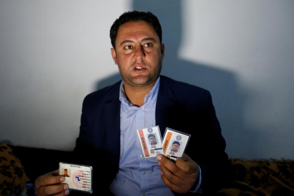  Botan Mahmoud Hassour shows his identity cards from when he was working with the US military. He had hoped to travel to the country as a refugee