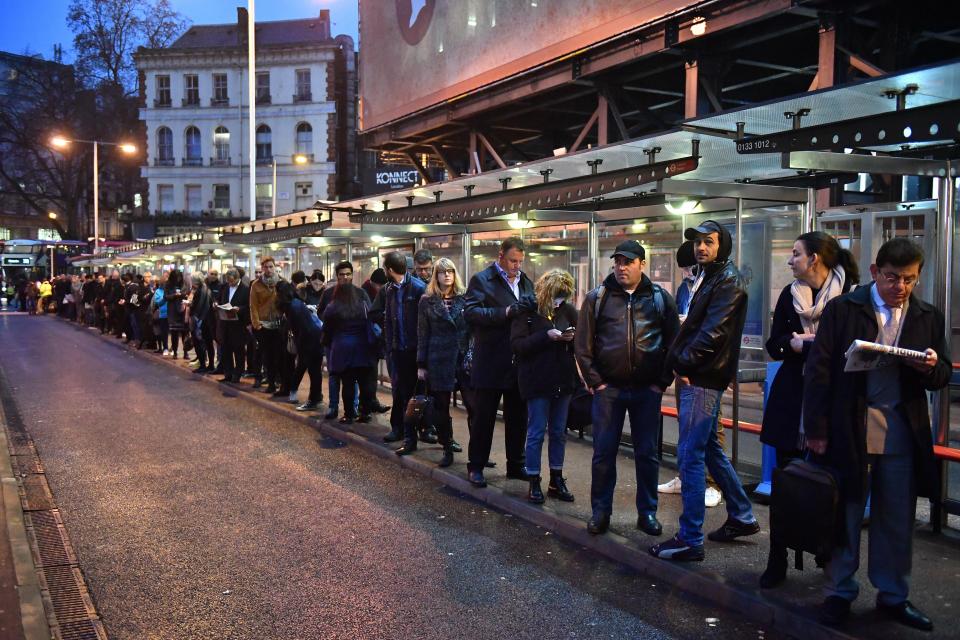  Commuters queue at Victoria station last month as they seek alternative travel home