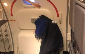 Passenger's anger after SAS air stewardesses used emergency exit door as a COAT HANGER on Heathrow flight