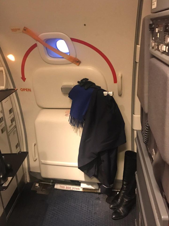 A shocked passenger snapped this picture of a coat, gloves and scarf hanging on a plane door