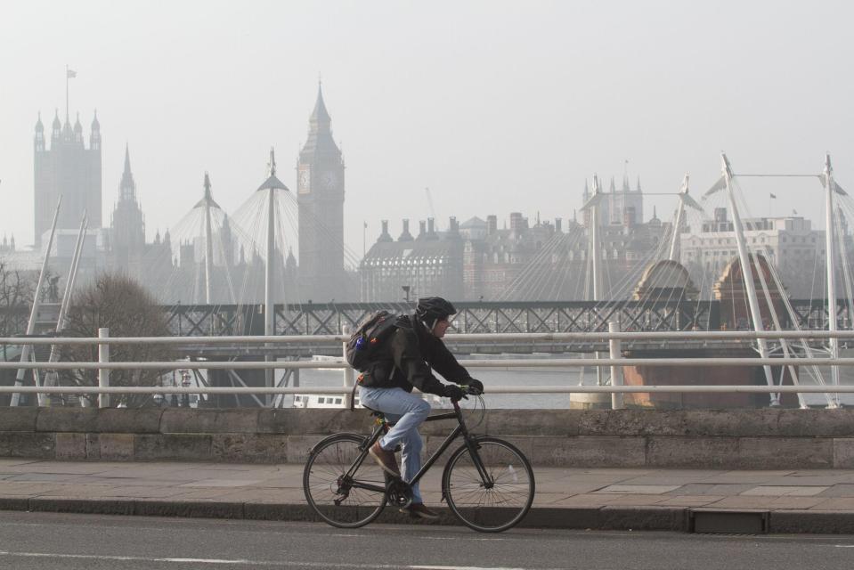  It was a grey start today for London as a cyclist makes their way over The Thames, with Big Ben in the background