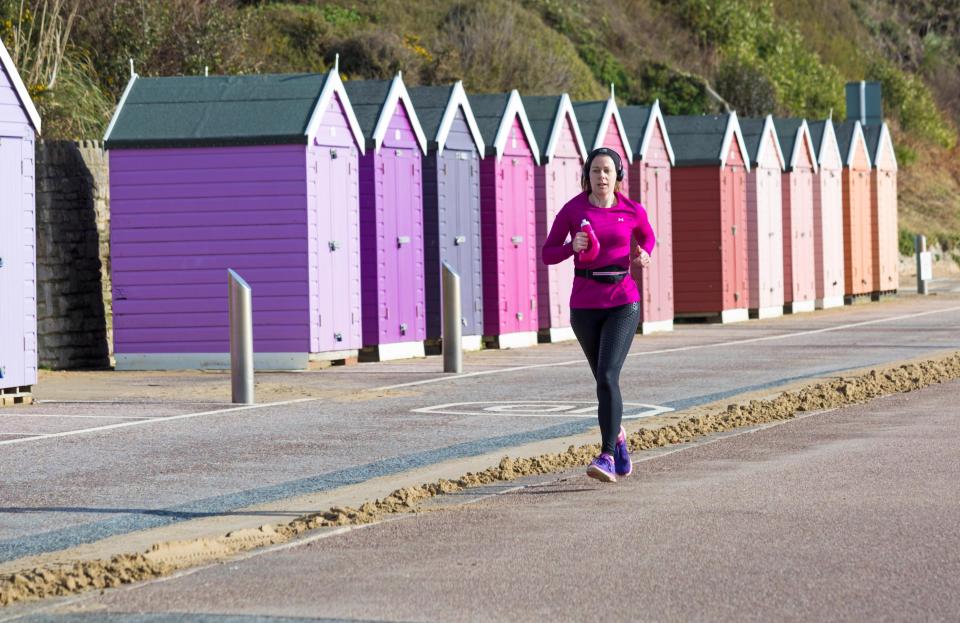 A runner makes the most of the sunny weather in Bournemouth today, as visitors headed to the seaside