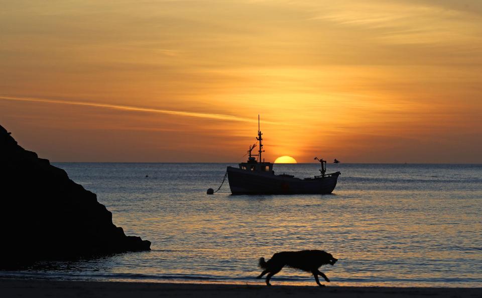  The calm before the storm, a fishing boat is anchored as the sun rises on Cullercoats beach in North Tyneside on Tuesday