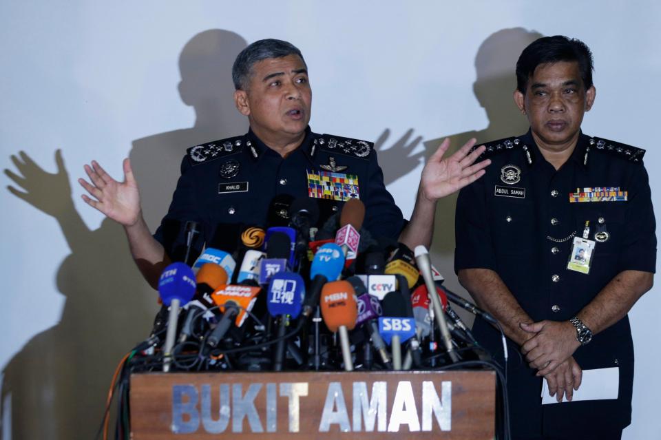 Malaysia's top cop Khalid Abu Bakar, left, today said police want to question the two men in connection with the killing
