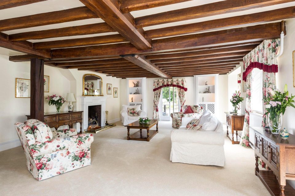  Packed with period features, the sitting room has a brick, inglenook fireplace, while the dining room and reception hall have flagstone floors