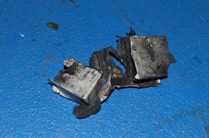  The charred remains of the 12V battery possibly used a power source for the bomb