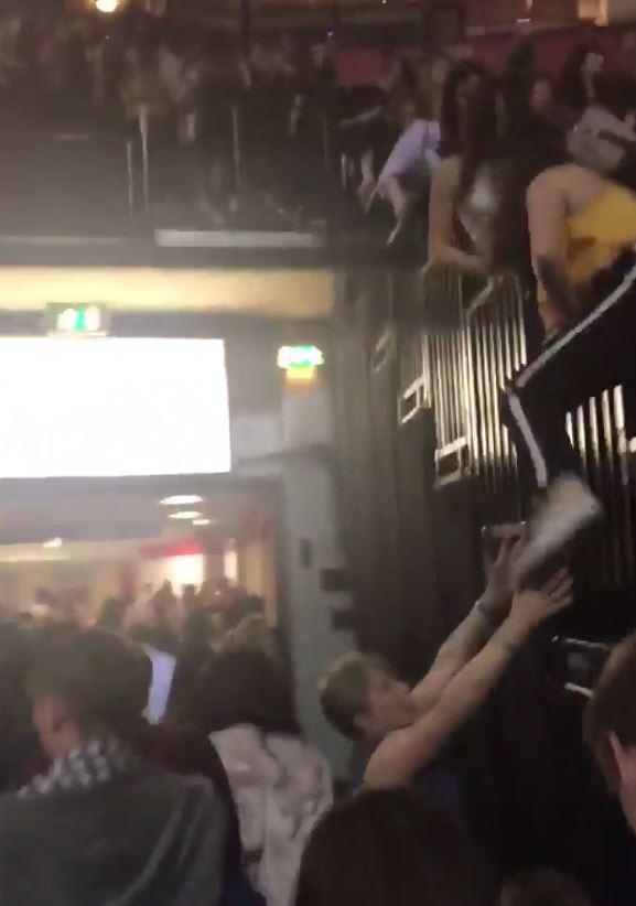 Fans vault over railings as they  flee the venue after hearing the massive blast