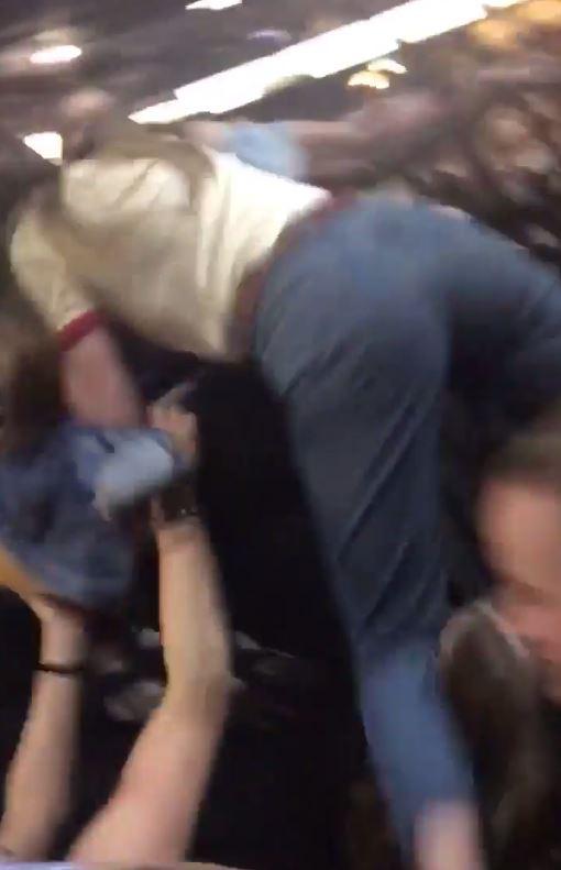  One girl is helped out of her seat as the panicked crowd rush to the exits