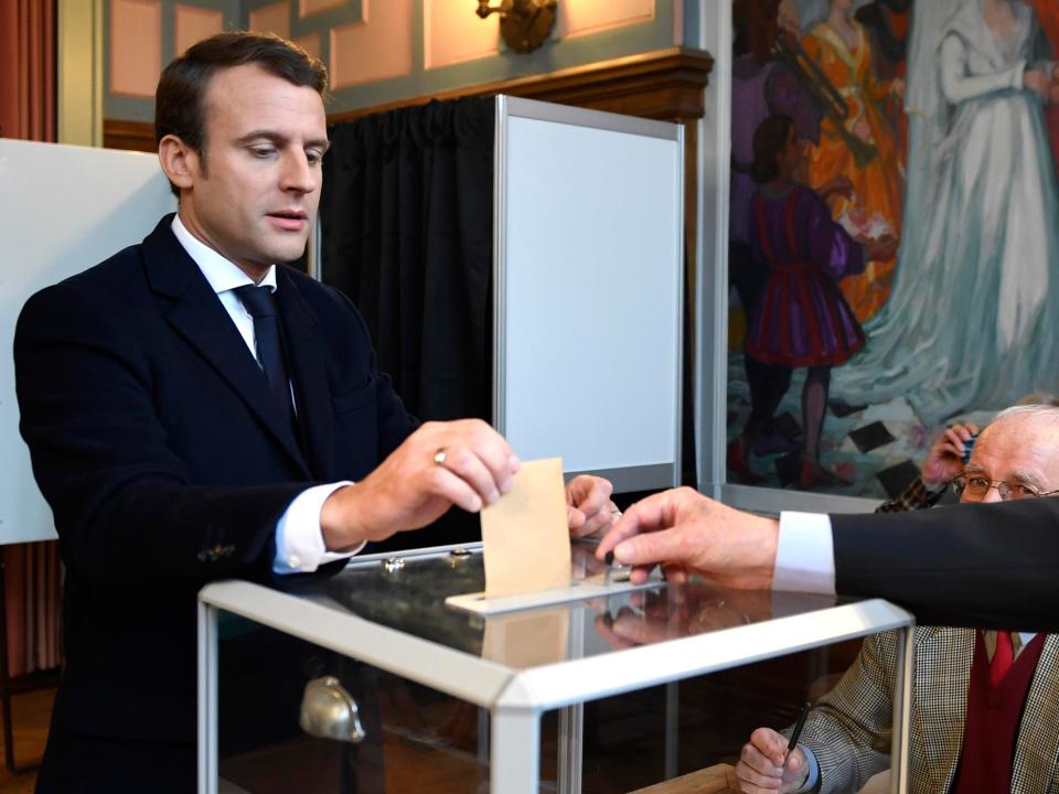  Favourite Emmanuel Macron casts his vote into an electoral box in Touquet, northern France