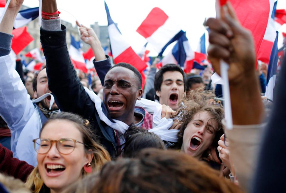  Macron supporters in Paris cheer his historic election win