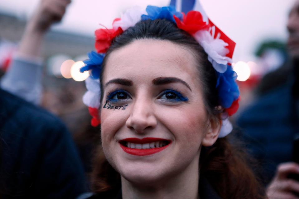  A smiling woman with French head gear clearly looks pleased at the result of the Presidential Election
