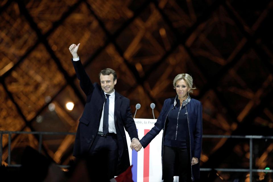  Macron waves to the crowd while standing with his wife Brigitte after making his victory speech in Paris
