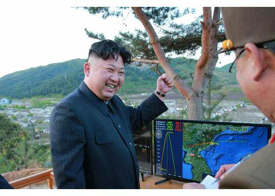  Kim Jong-un cheers as he watches a screen showing the successful launch of a 'new type' of ballistic missile at the weekend