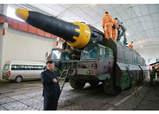  Kim is pictured standing beside the powerful rocket before Sunday's launch