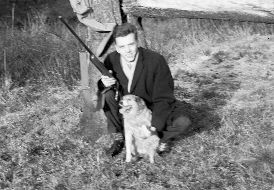  Here he is pictured with a pet dog and a hunting rifle