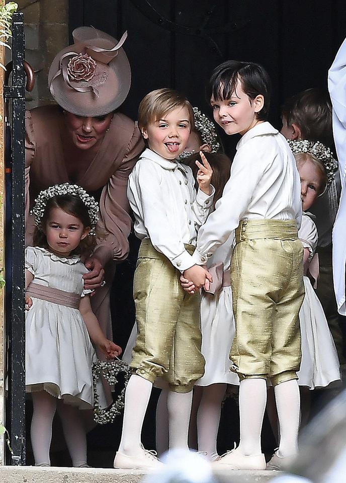  One naughty page boy appeared to stick out his tongue at photographers