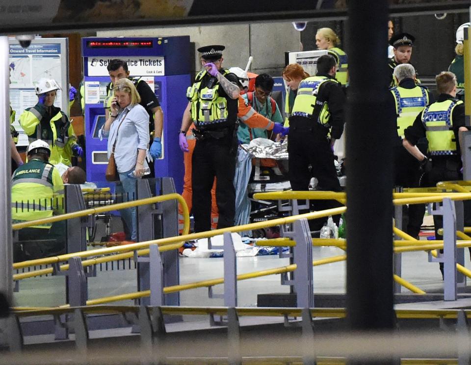 Police treat victims on the platform at Victoria Station